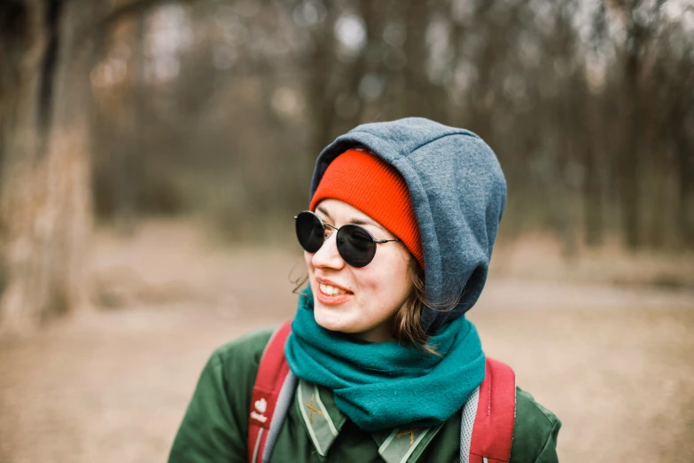 a young woman with glasses and a bright red and blue scarf