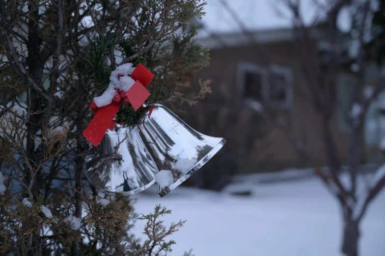 a bell that has some red ribbon around it