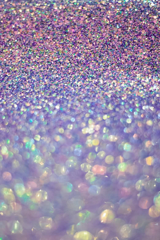 a close up po of colored glitter on a white background