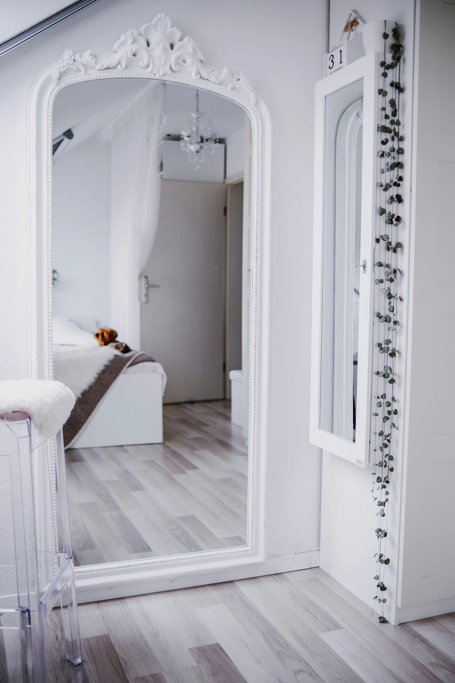 a large mirror with a couch in the background