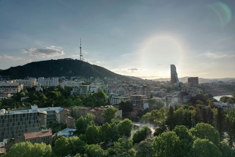 a cityscape with tall buildings near a mountain