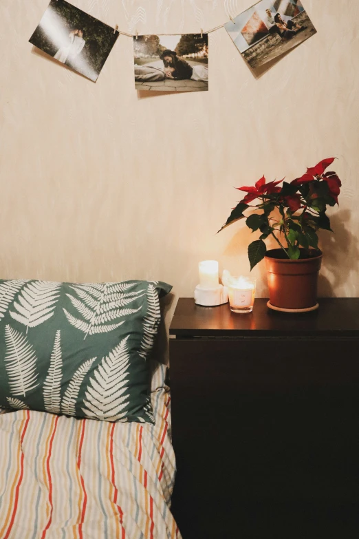 a bed room with a lamp a candle and pictures