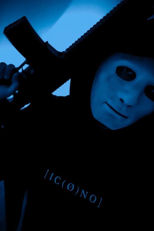 a masked man wearing a black shirt has a text written across it