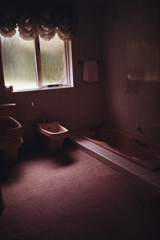 an empty bathroom with a large tub and two sinks