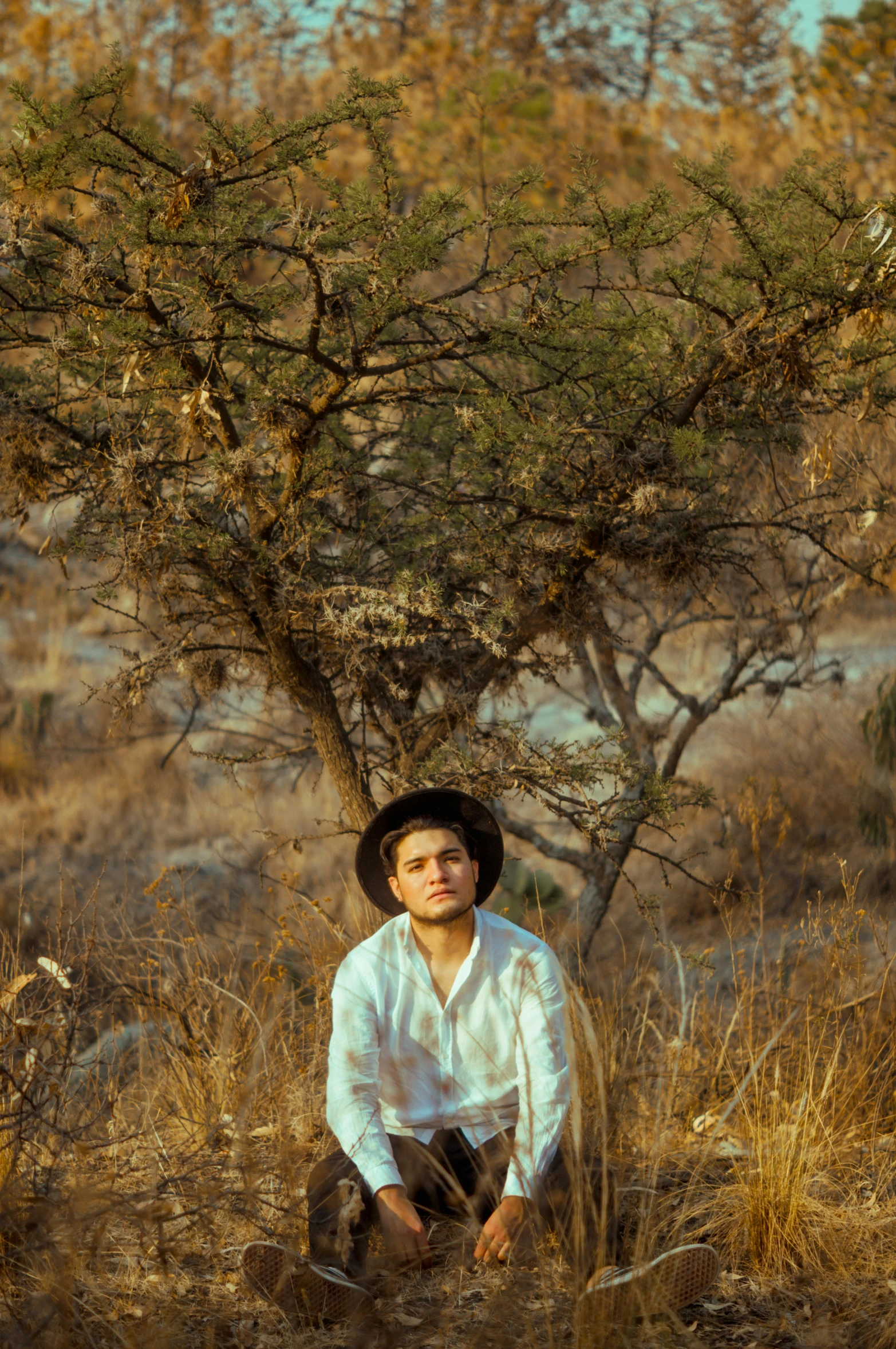 the young man in a hat is posing for a picture