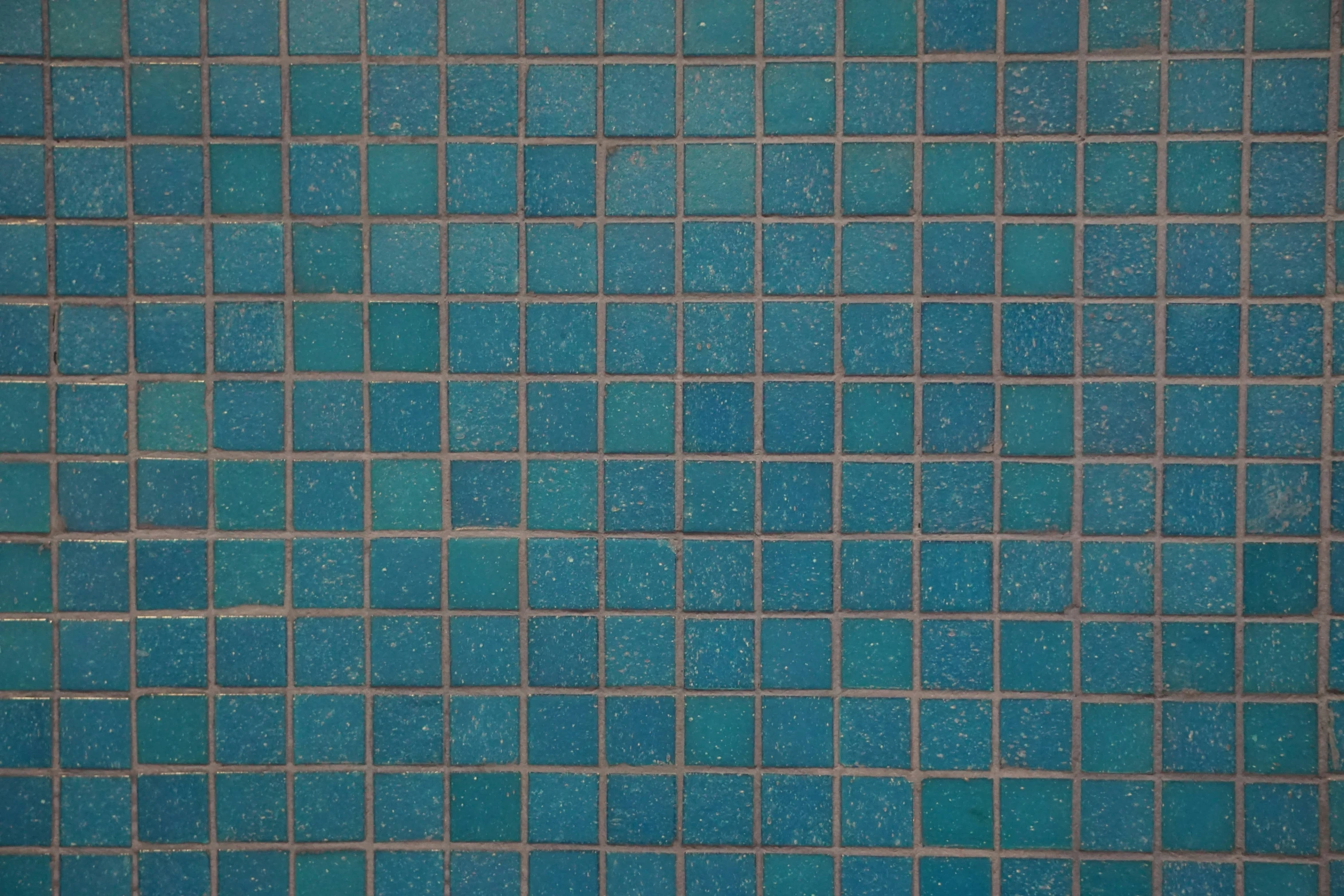 a bath tub filled with a blue mosaic tile