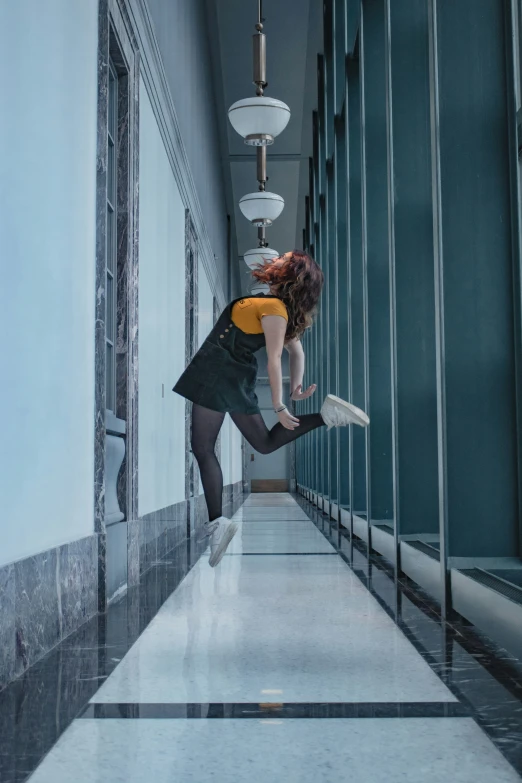 a woman jumping in a corridor on top of her hands