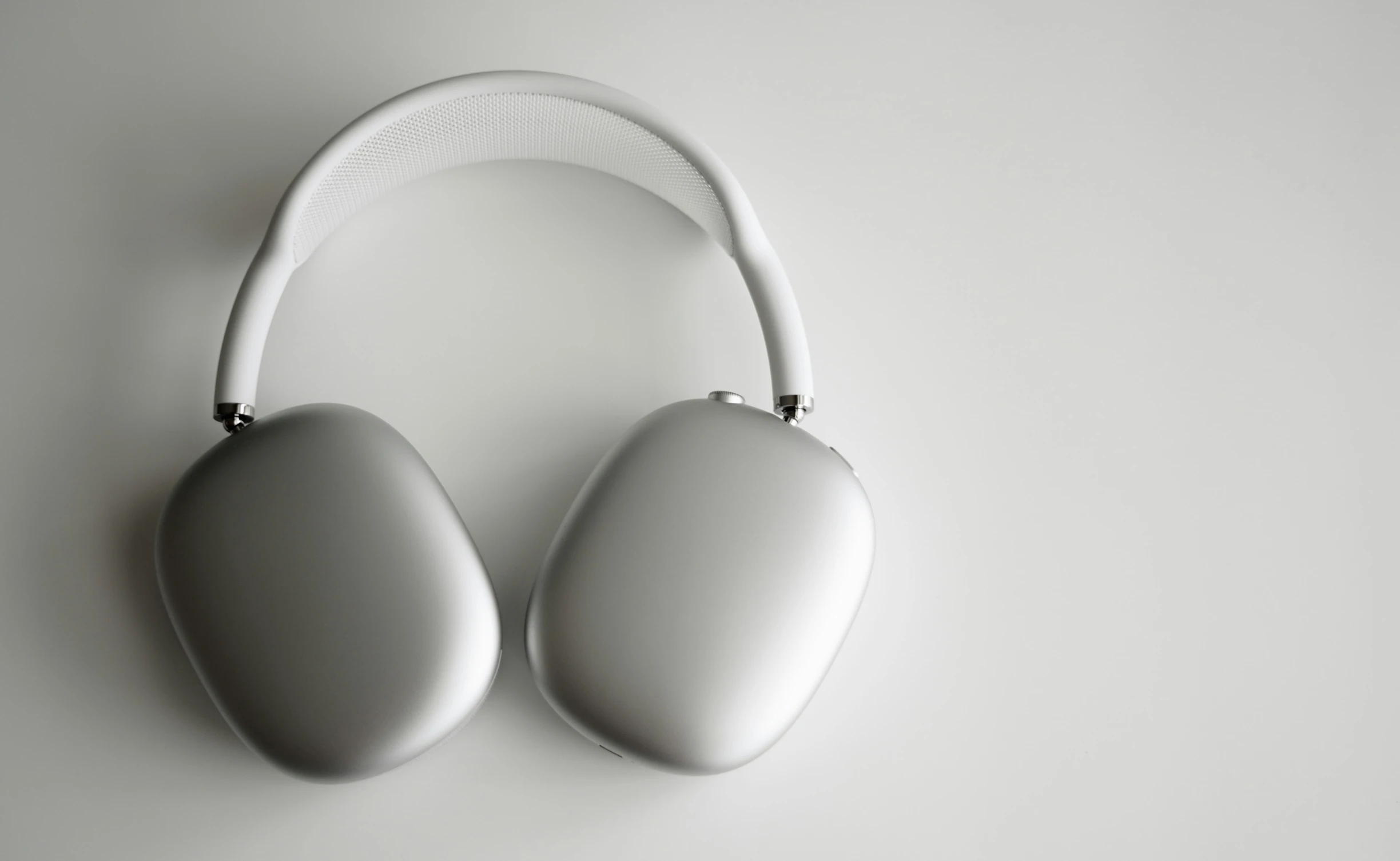 a pair of headphones laying on top of a white surface