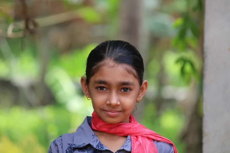 a smiling  with pink scarf on her neck