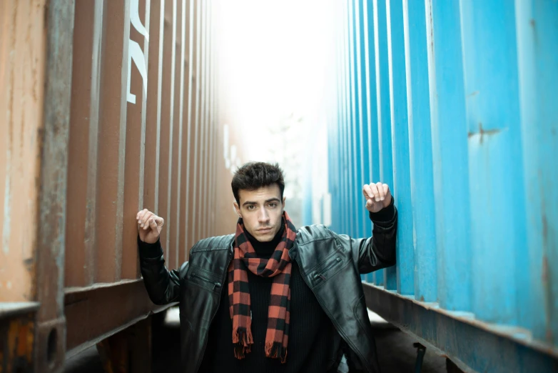 a young man is standing near the train car