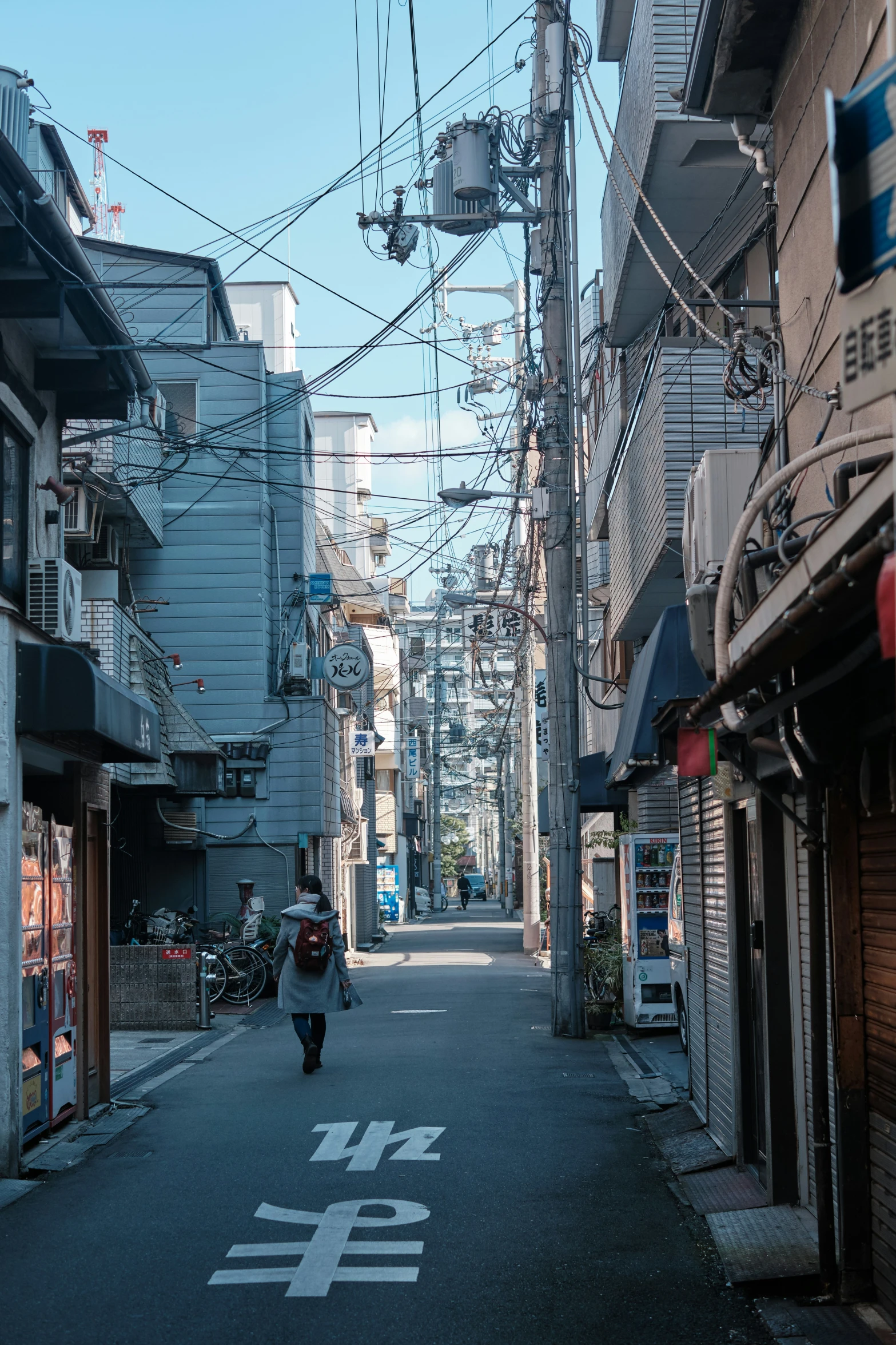 a person riding down the middle of a narrow alley