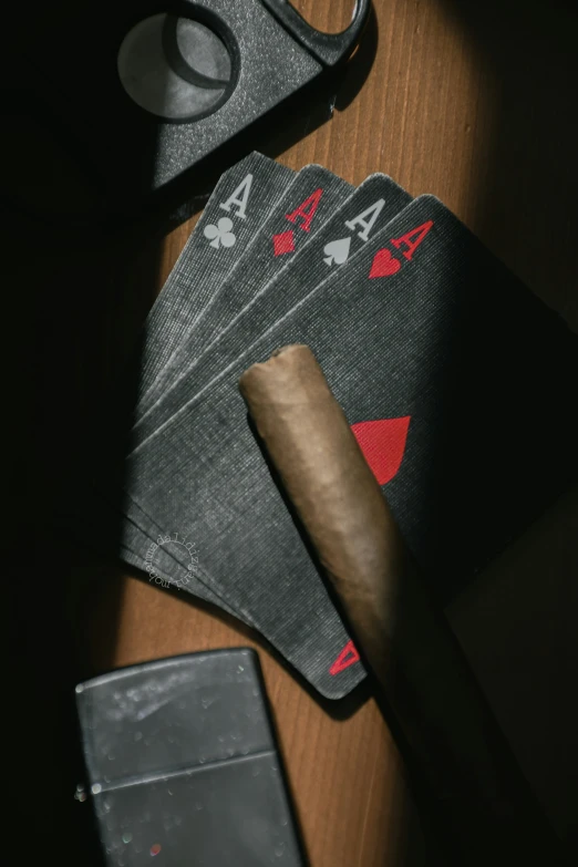 five cards and a cigar on top of a table