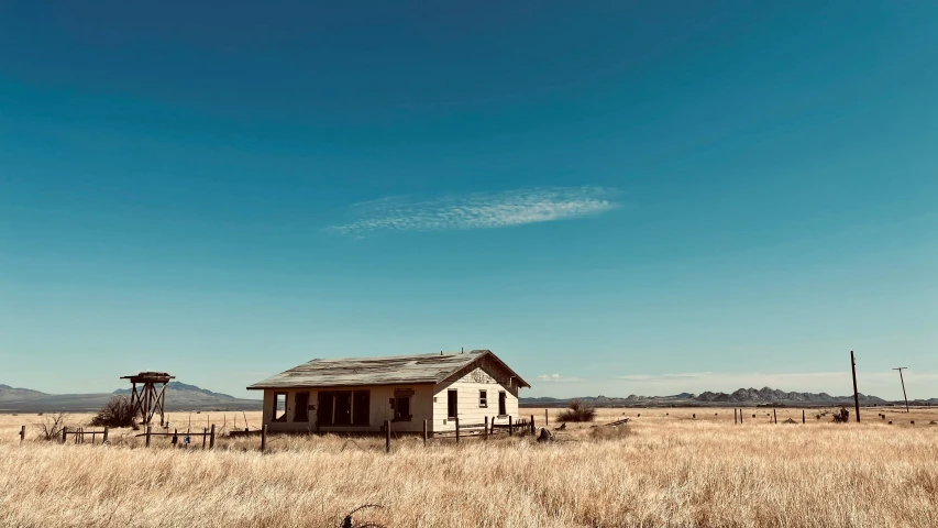 an old abandoned building sitting in the middle of nowhere