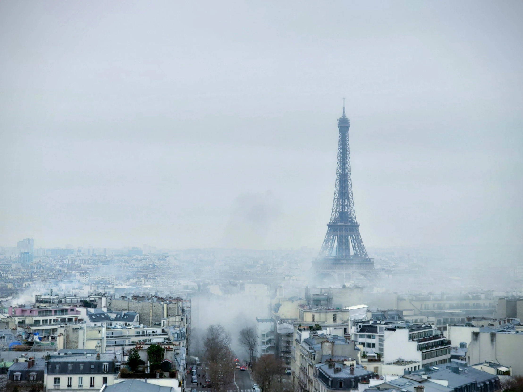 the eiffel tower in the fog is pictured