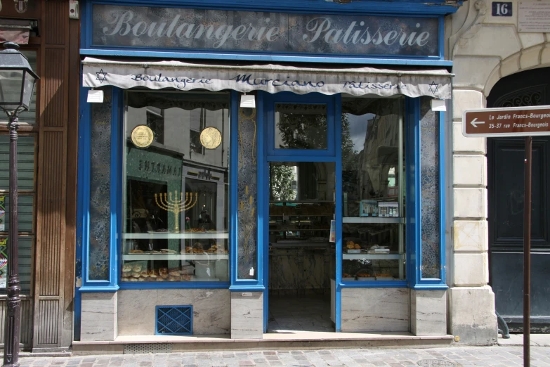 a blue and white store front on a city street