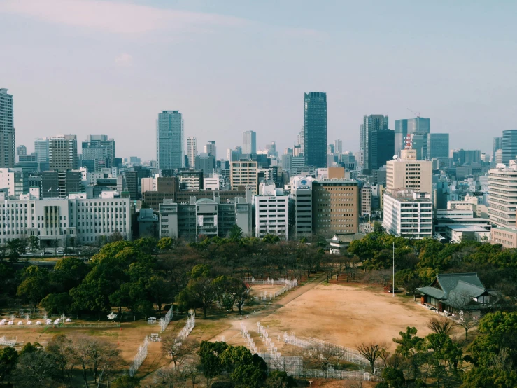 a city with tall buildings and a playground