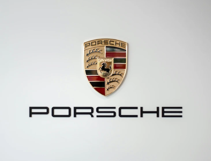 a porsche logo is shown with a chrome plate