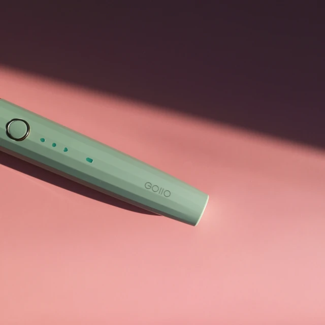 a close up view of the green on of a toothbrush