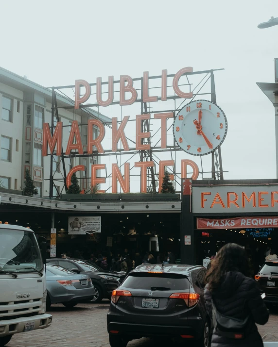 there is a woman standing next to some cars