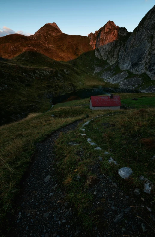 a grassy field with a house in it