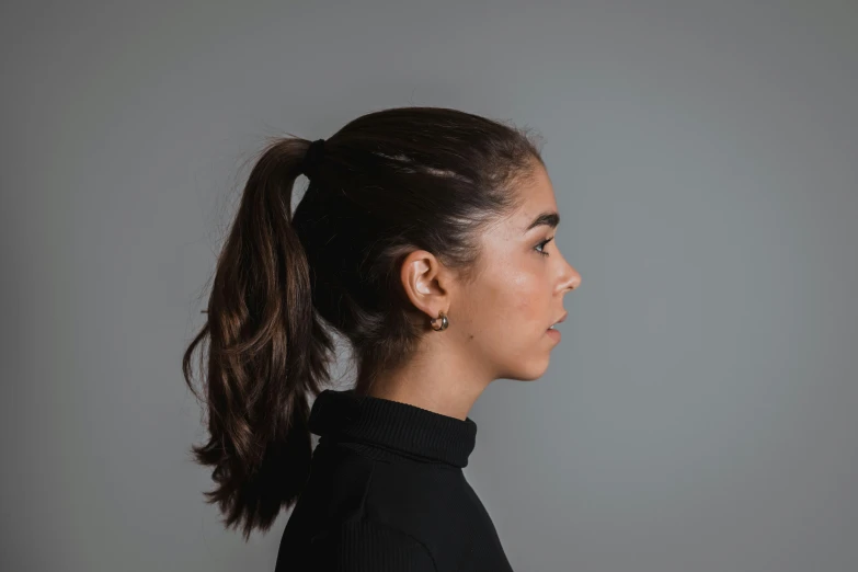 a woman wearing a black shirt and ponytail