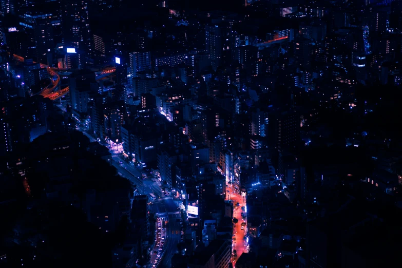 a night view from an aerial point - perspective showing traffic lights, buildings and a street