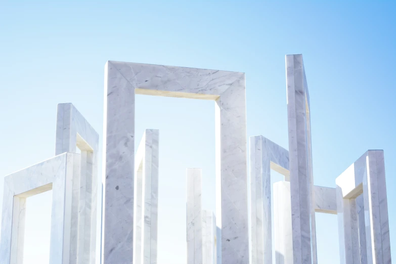 two tall white frames with a blue sky in the background