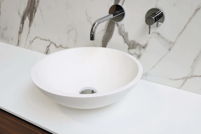 this white bowl has a faucet to the side of it