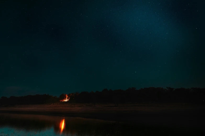 a green light shines brightly above the forest