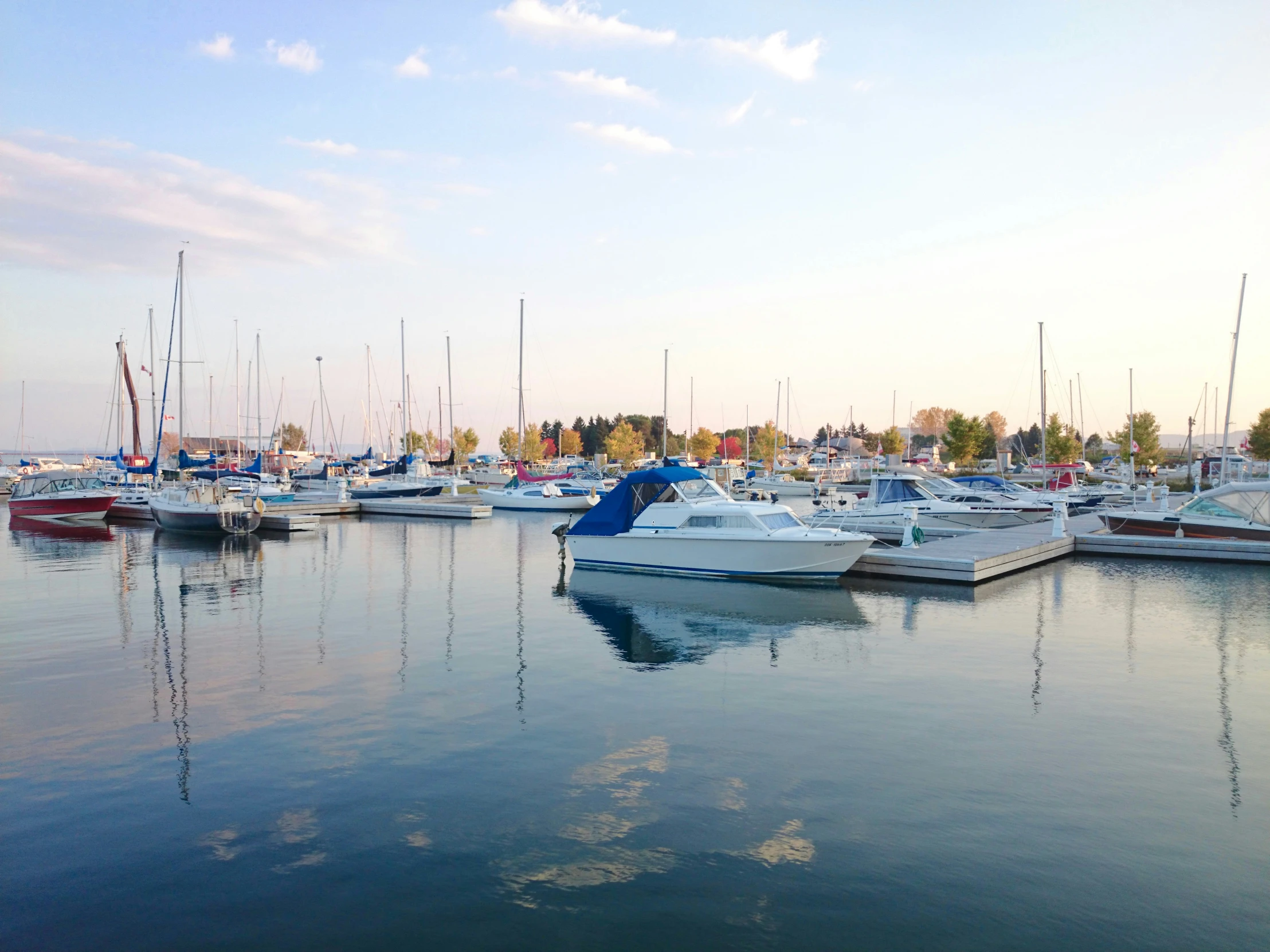 some boats are docked in a lot that is near water