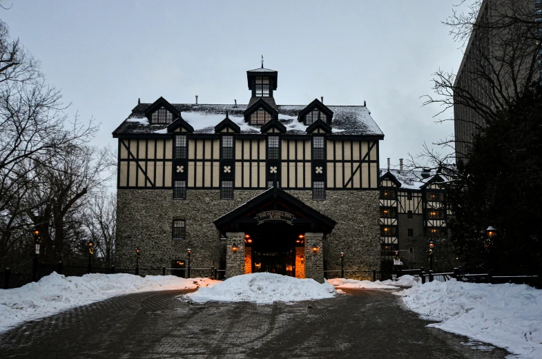 a large building with an entrance on a snowy day