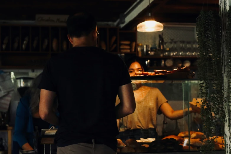 a young man is standing in front of the counter