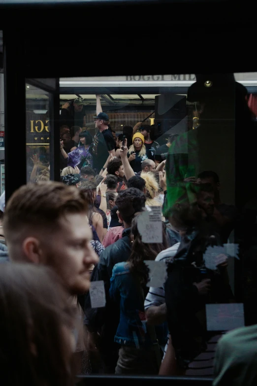 a crowd of people walking on the street