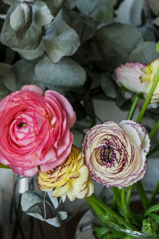 a vase full of pink and yellow flowers