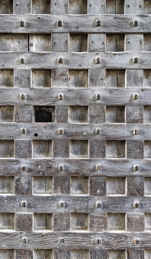 a wall made out of wooden boards with a hole at the end