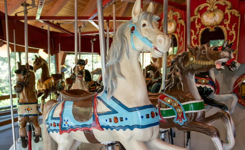 a merry go round horse with an assortment of riders