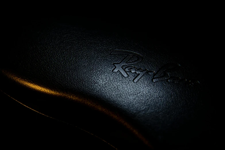 a close up view of a black leather seat