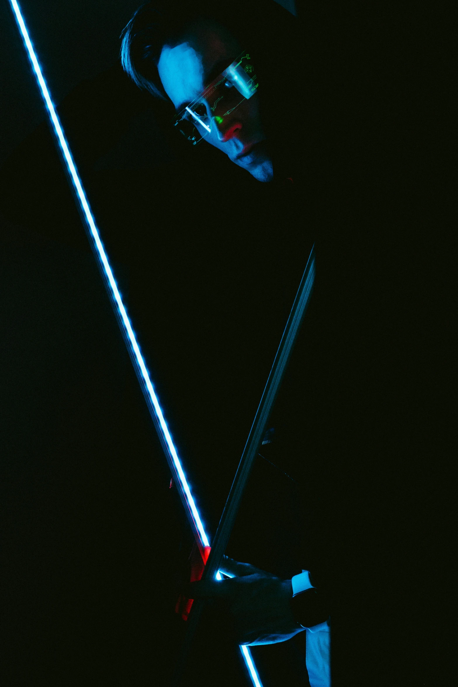 a dark image of a lighted sword and a flashlight