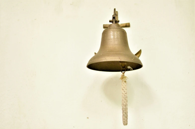 a bell with an anchor attached to it