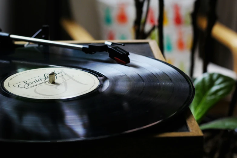 a record player playing a black music vinyl