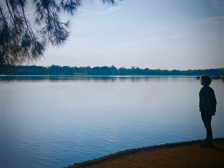 a person standing at the edge of a body of water