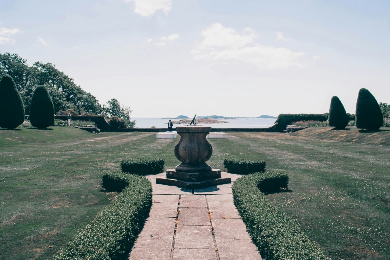 a sculpture stands alone in the middle of an open field