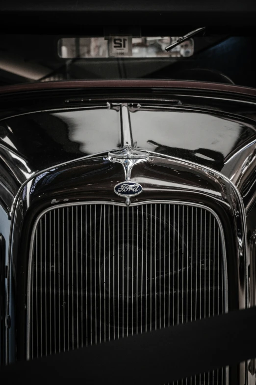 the front of an old vintage car with chrome trims