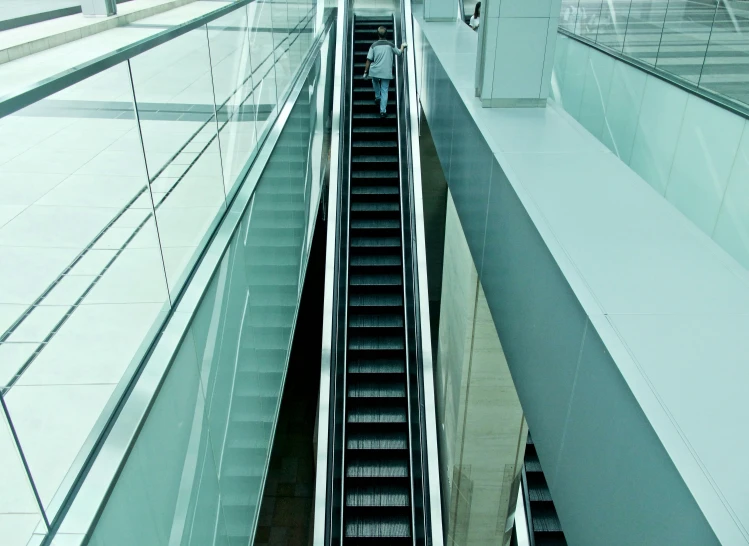 a moving escalator has a lot of people walking up it