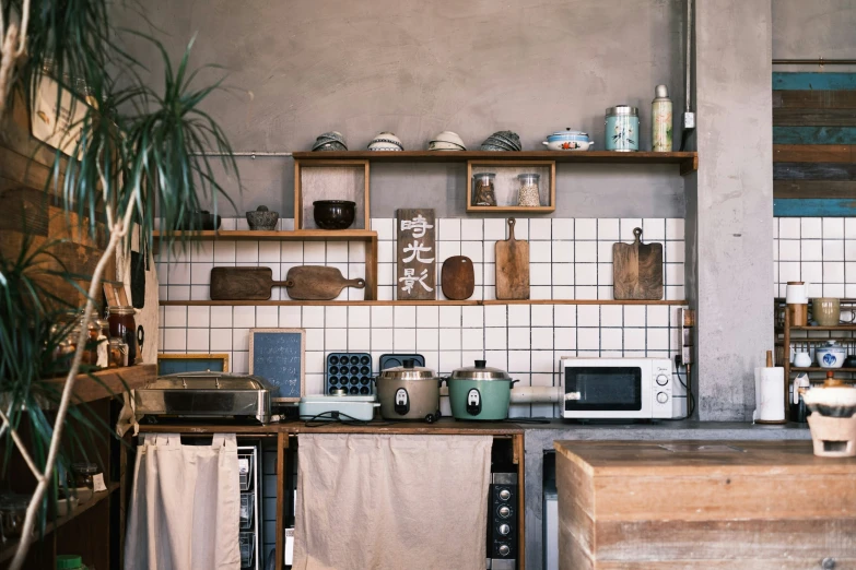 a kitchen with lots of dishes and pots on the counter