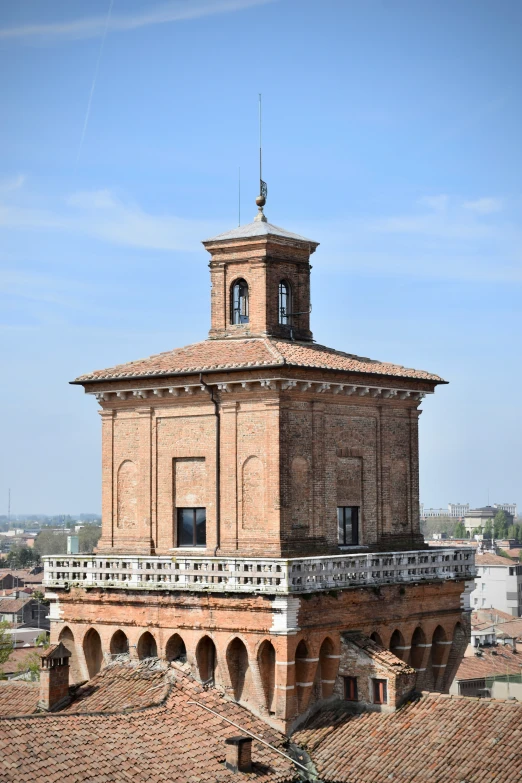 a building with a roof and balcony area on a sunny day