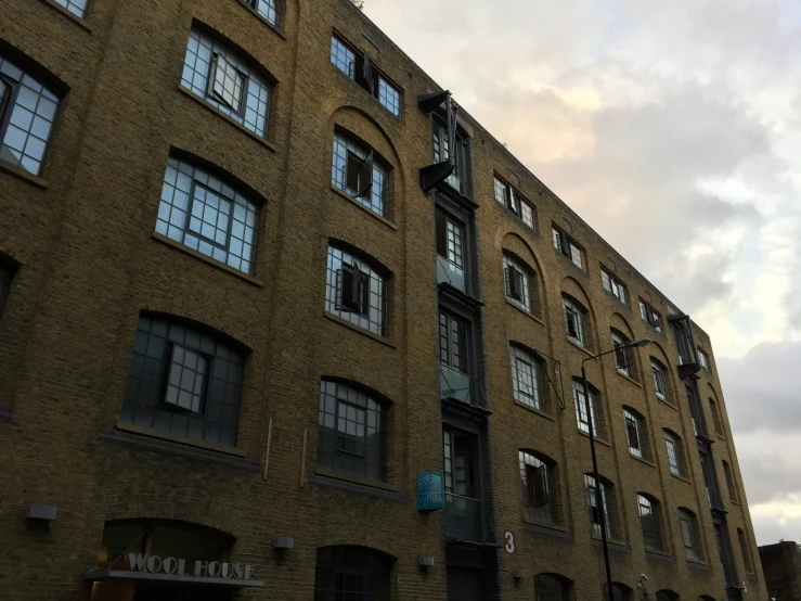 a tall brown brick building with many windows