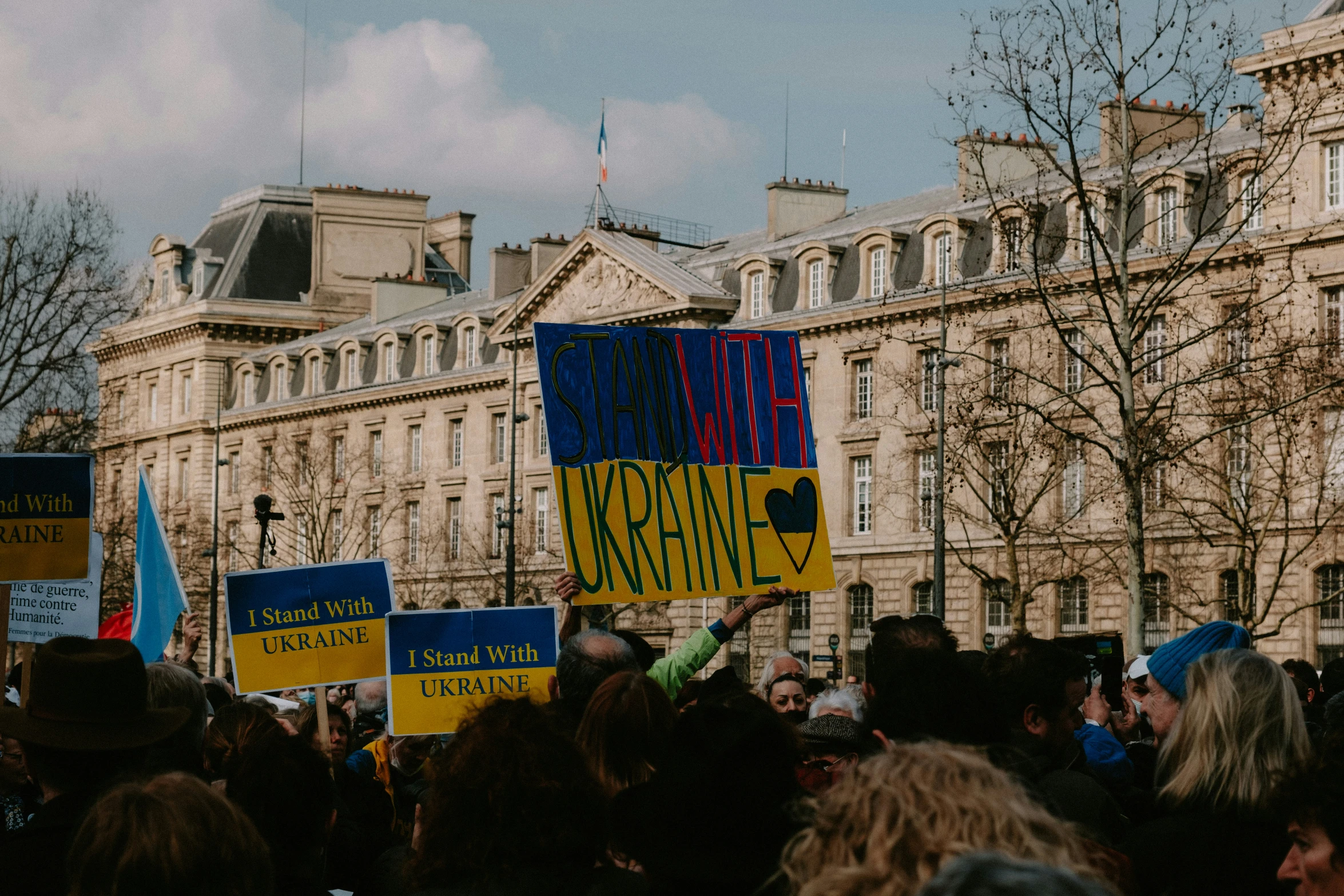 an event with people standing around and holding up colorful signs