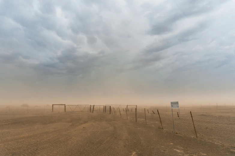 a desert with a line of posts on the side