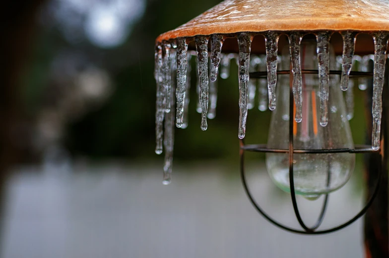 icicles hang from a lamp fixture on a cold day